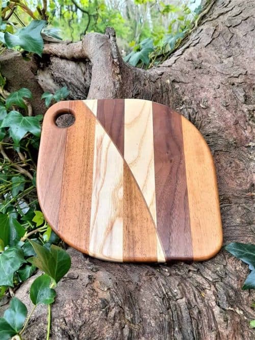 The Burnt Caramel Fondue Cheese Boards combine contrasting the colours and textures of Walnut, Iroko & Ash in elegant patterns. My Fondue Cheese Boards are Individually Handmade at my workshop in Malahide, Co. Dublin, each is Unique and will differ from others in the collection.
