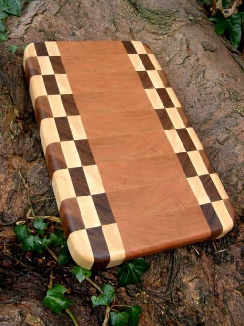 The Dunree End Grain Chopping & Cutting Board is Handmade in Cherry with a striking checkerboard pattern in Maple & Walnut. Dunree is fitted with recessed handles for easy lifting and finished with Antibacterial Worktop Oil.