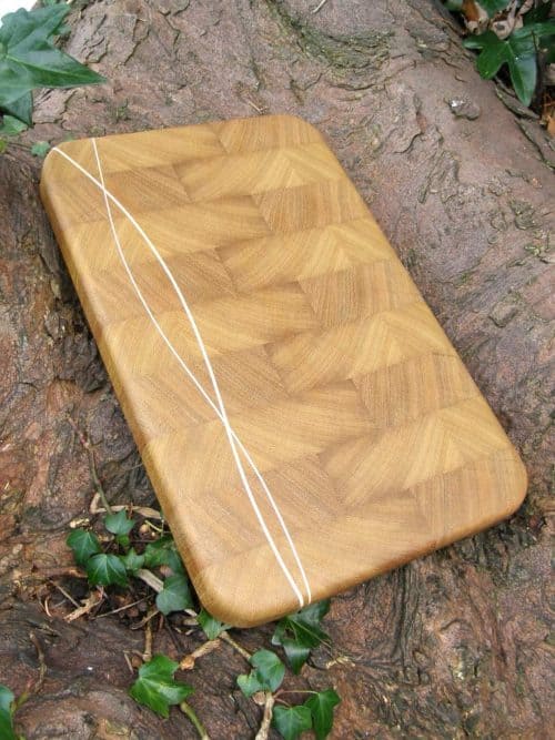 The Hook Head End Grain Chopping & Cutting Board is Handmade in Iroko with Maple wave inlay running down one side of the board. Hook Head is fitted with recessed handles for easy lifting and finished with Antibacterial Worktop Oil