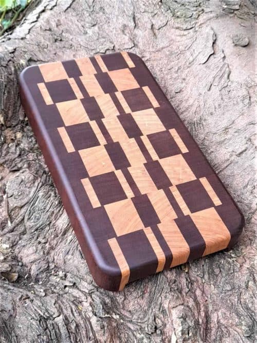 The Kish End Grain Board Chopping & Cutting Board is Handmade in a striking pattern using Sapele & Oak. Kish is fitted with recessed handles under each end of the board for ease of lifting,  and finished with Antibacterial Worktop Oil.