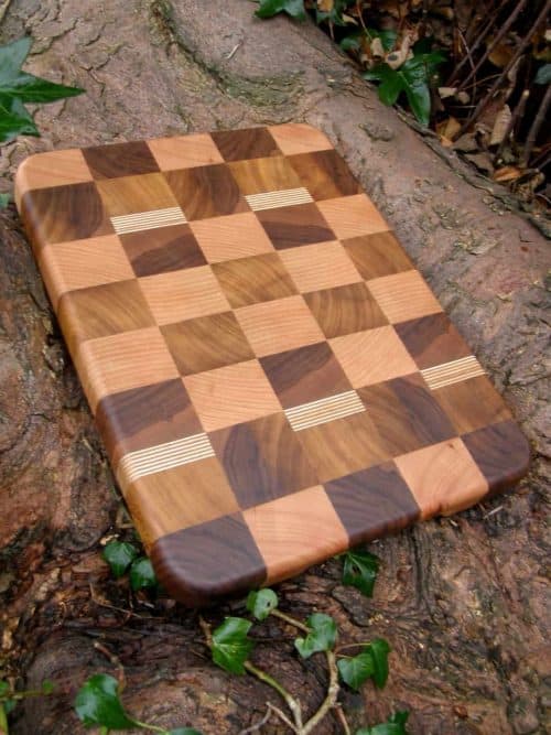 The Schooner Wave End Grain Chopping & Cutting Board is Handmade in Walnut, Cherry, Iroko & Birch Ply. The Schooner Wave End Grain Chopping Board is fitted with recessed handles, under each end of the board for ease of lifting and finished with antibacterial worktop oil. 