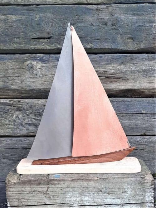 Wavecrest III - limited edition Copper and Stainless Steel Yacht Model. Wavecrest III - limited edition Copper and Stainless Steel Yacht Model on a Port Tack.   This Stylized Yacht Design is designed with a brushed Stainless Steel Mainsail with Copper Headsail,  on a Walnut Hull.    