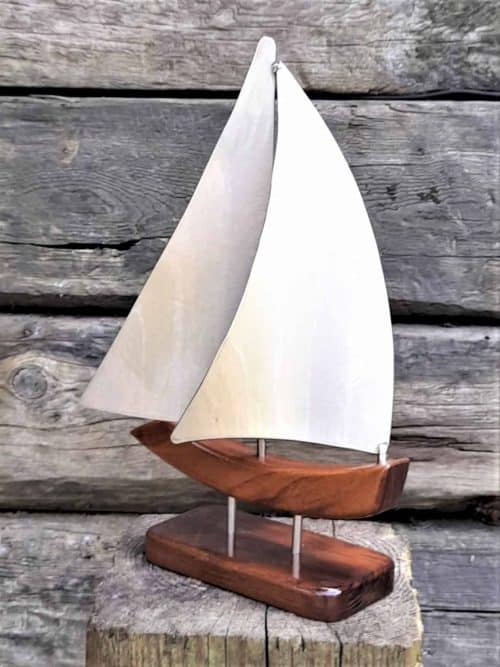 Zanzibar XXIV is a Limited Edition Yacht Model designed in Stainless Steel, inspired by a child's drawing of a sailing boat. She features Brushed Stainless Steel Main & Head Sails,  sailing on a Port Tack.