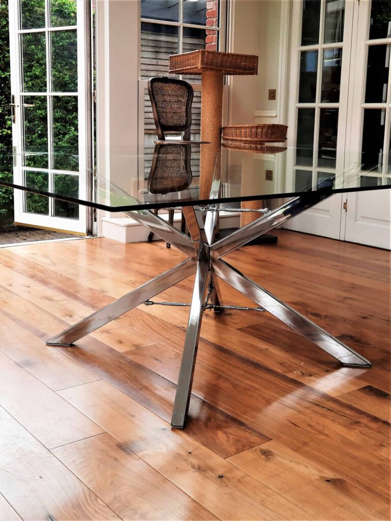 Stainless Steel Spider Dining Table with Bottle Screw Nautical detail with toughened glass top - Handmade in Stainless Steel by Grant Designs